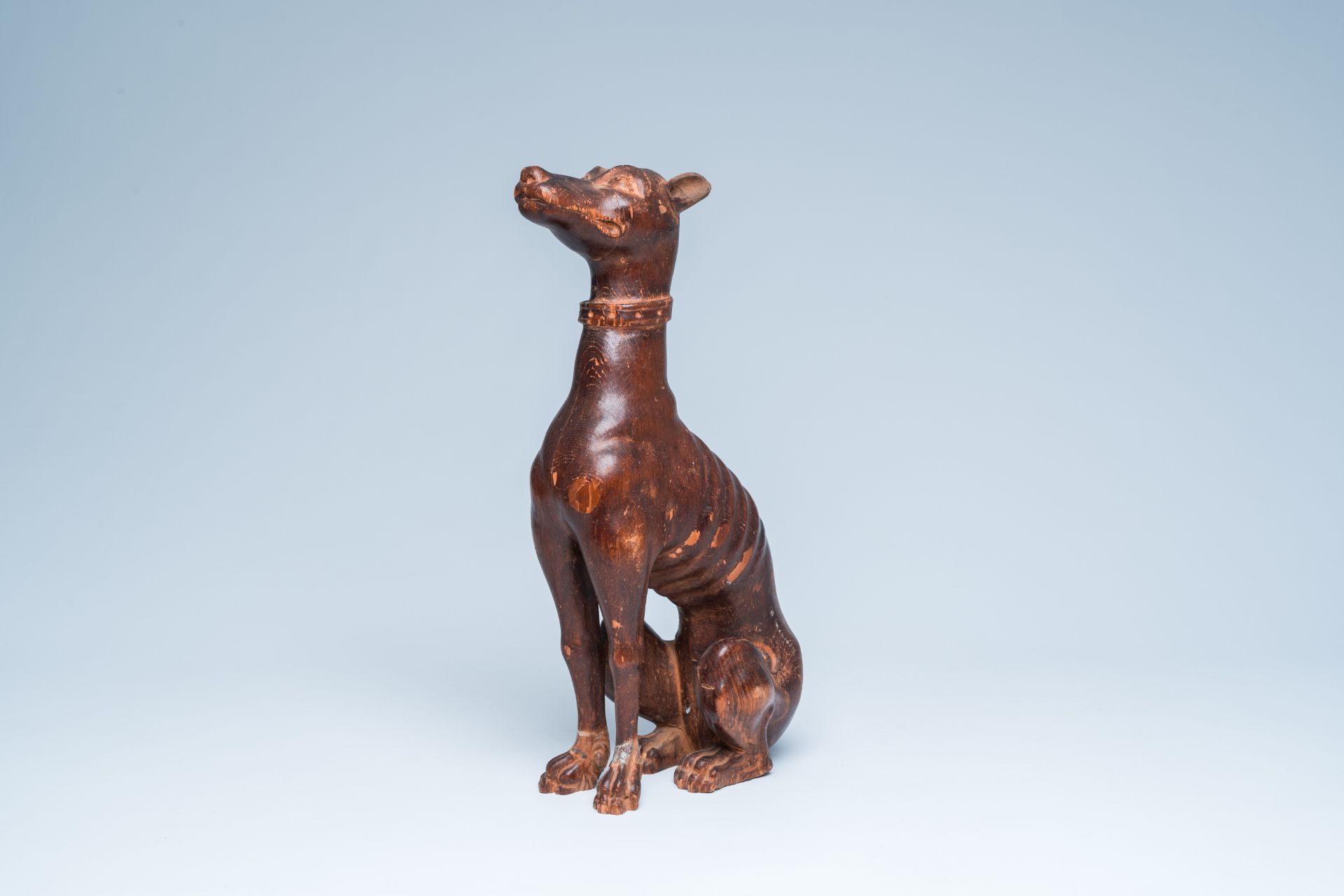 A carved and patinated wood model of a greyhound, 19th/20th C.