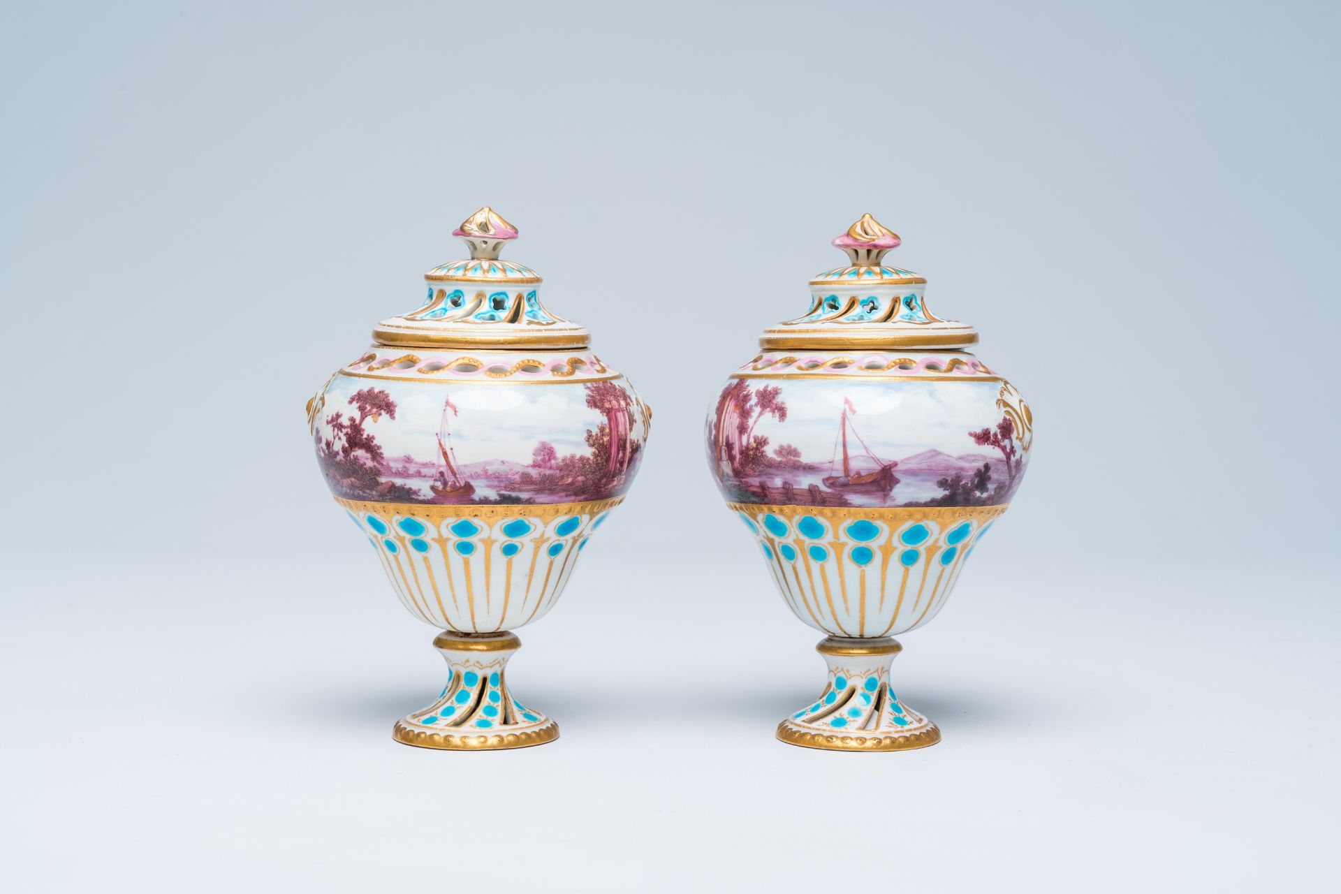A pair of polychrome and gilt pot-pourri vases and covers in the Tournai manner with a landscape all