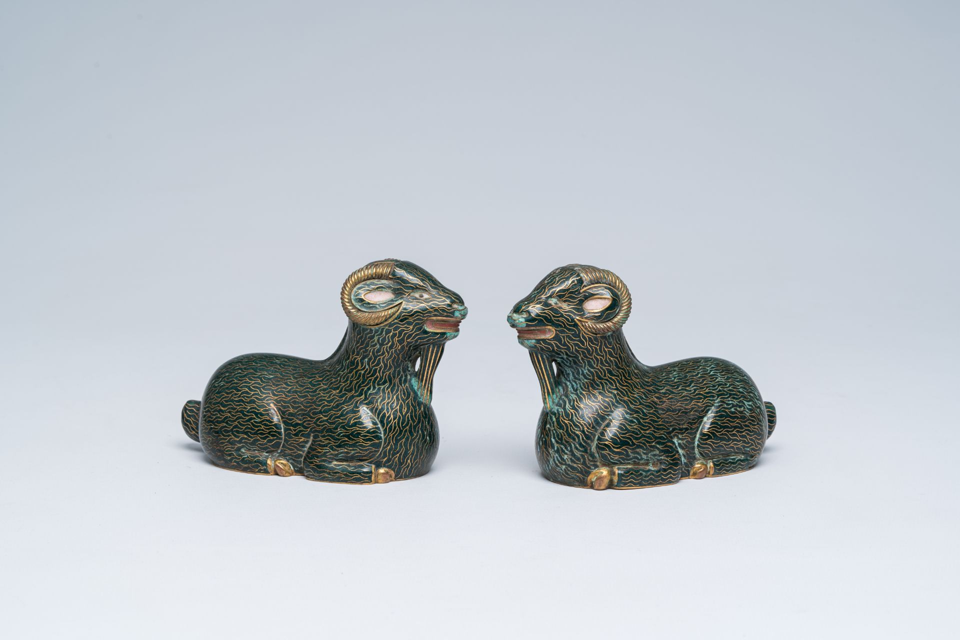 A pair of Chinese cloisonne models of rams, 20th C.