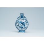 A Chinese blue and white moon flask with Buddhist lions and floral design, 19th C.