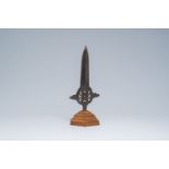 An open worked wrought iron spearhead on a wood stand, 19th C. or earlier
