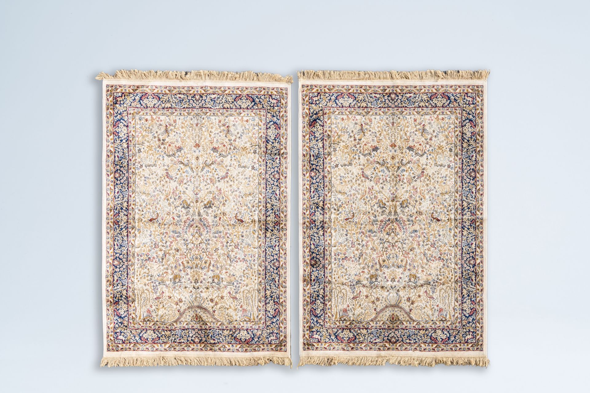 A pair of Iranian Kashmir rugs with birds among blossoming branches, silk on cotton, 20th C.