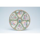 A Chinese Canton famille rose charger with palace scenes and birds and butterflies among blossoming