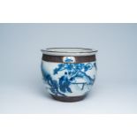 A Chinese Nanking crackle glazed blue and white jardiniere with scholars and their servants in a lan