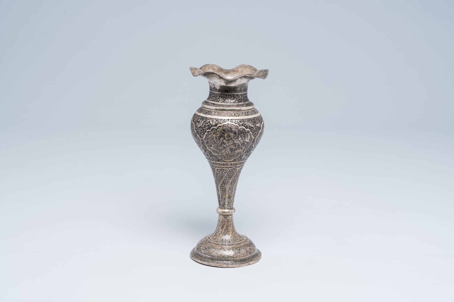 A Persian silver Shiraz vase with animated medallions, floral design and a dedication, Iran, first h