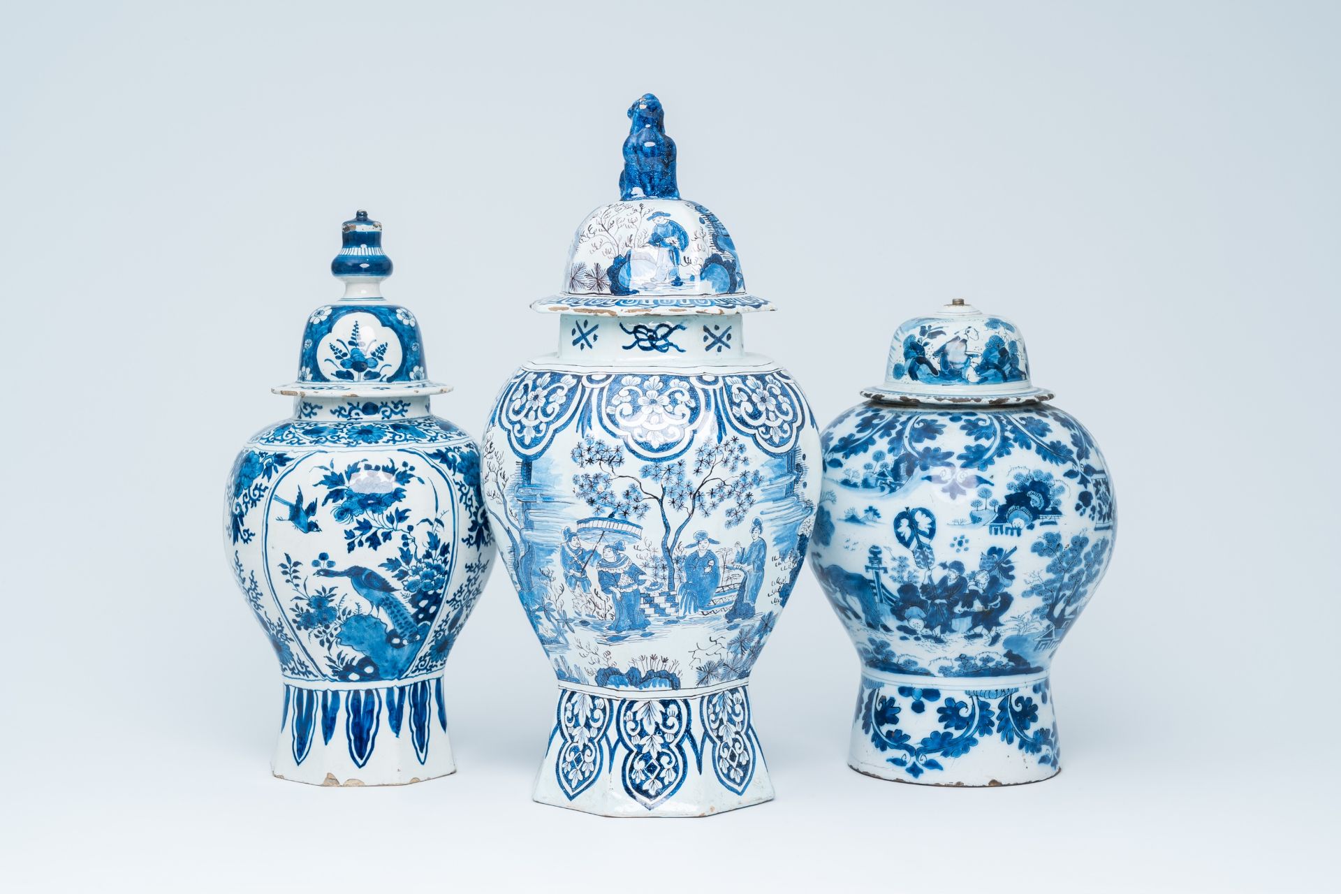 Three Dutch Delft blue and white vases and covers with birds among blossoming branches and chinoiser