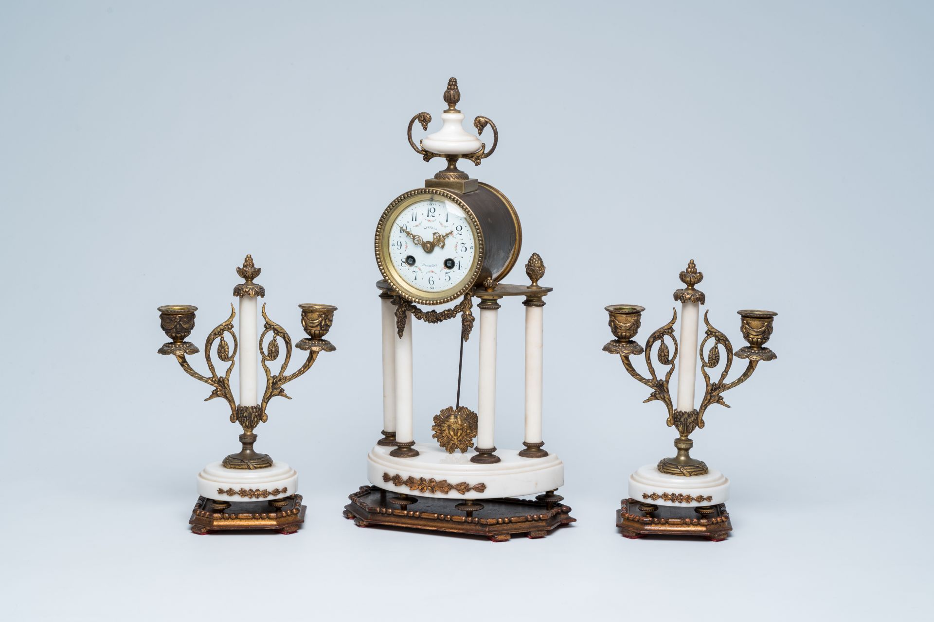 A Belgian Neoclassical gilt bronze mounted white alabaster three-piece clock garniture, Luppens Brus