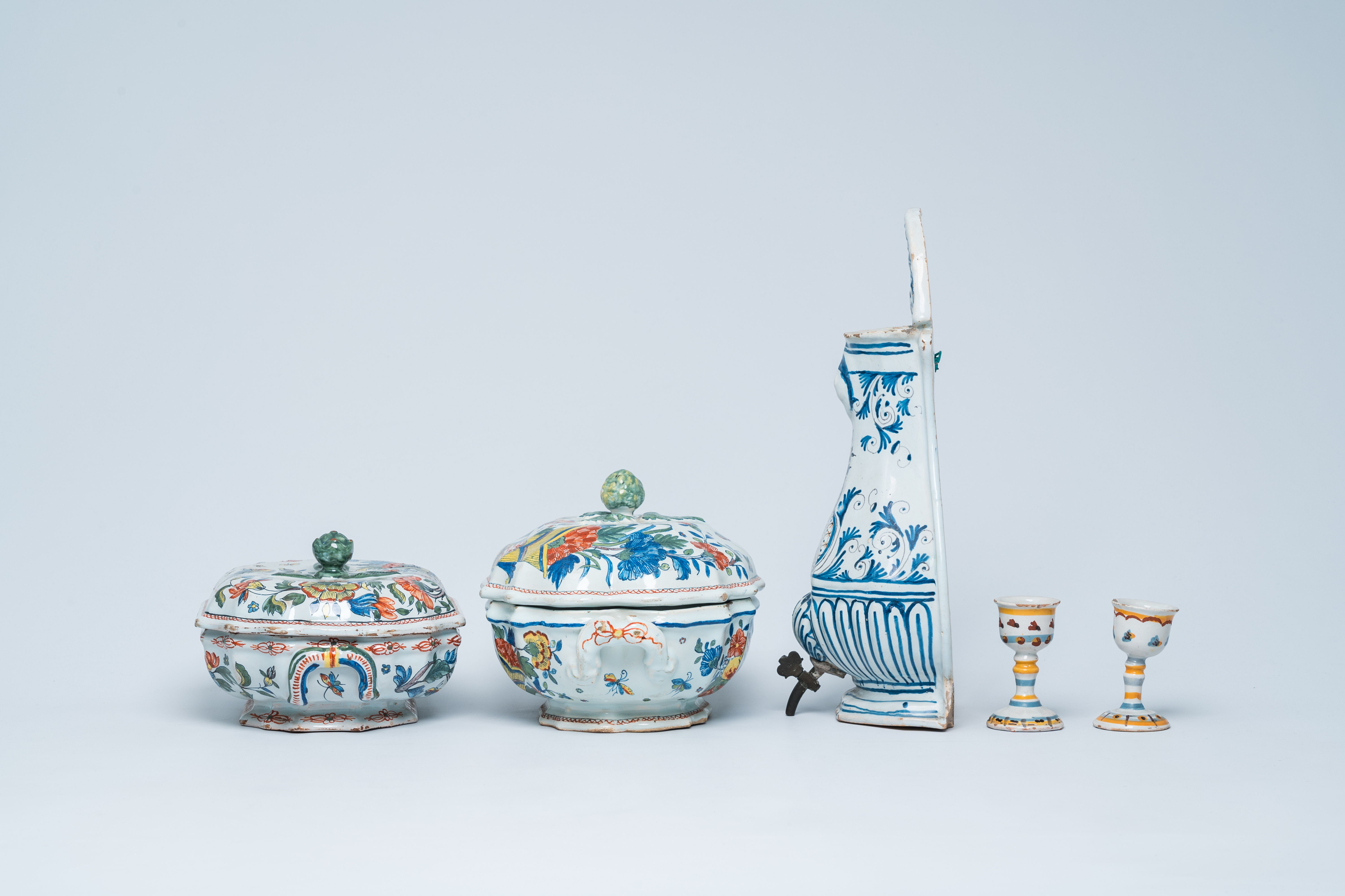 Two polychrome French Rouen faience tureens and covers, a pair of egg cups and a wall fountain, 18th - Image 5 of 9