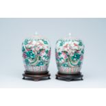 A pair of Chinese famille rose jars and covers with phoenixes among blossoming branches, 19th C.