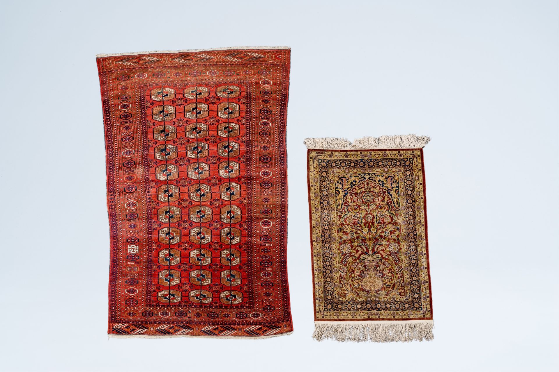 A Turkmen Tekke rug, wool on cotton, and an oriental rug with floral design, silk on cotton, 20th C.