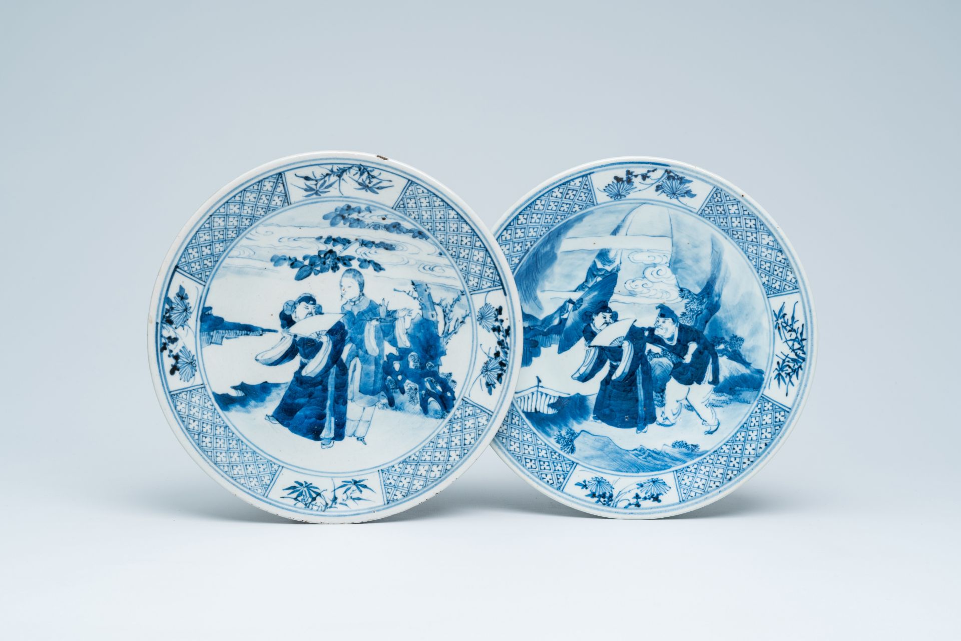 Two Chinese blue and white plates with figures in a landscape, 19th C.