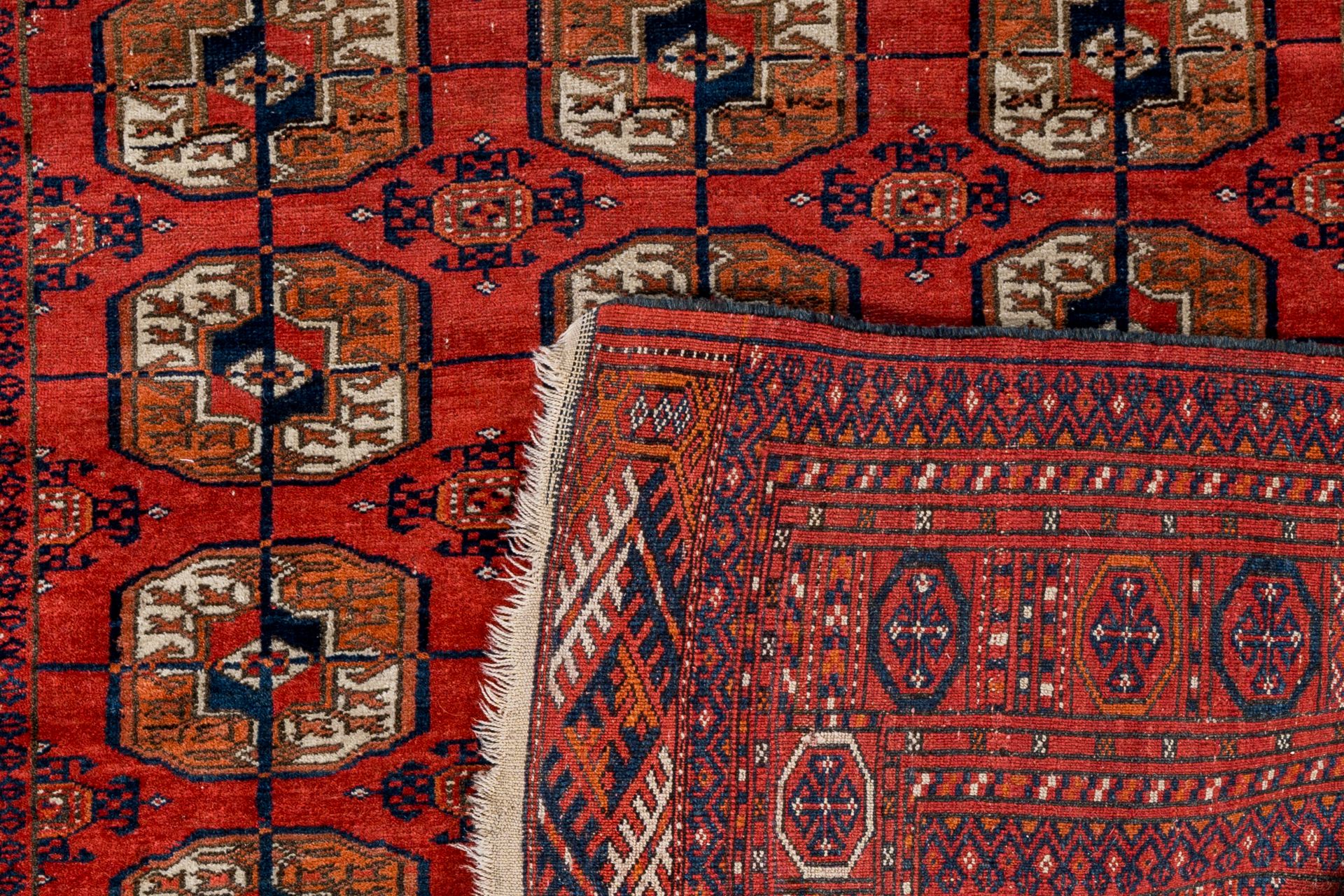 A Turkmen Tekke rug, wool on cotton, and an oriental rug with floral design, silk on cotton, 20th C. - Image 4 of 4