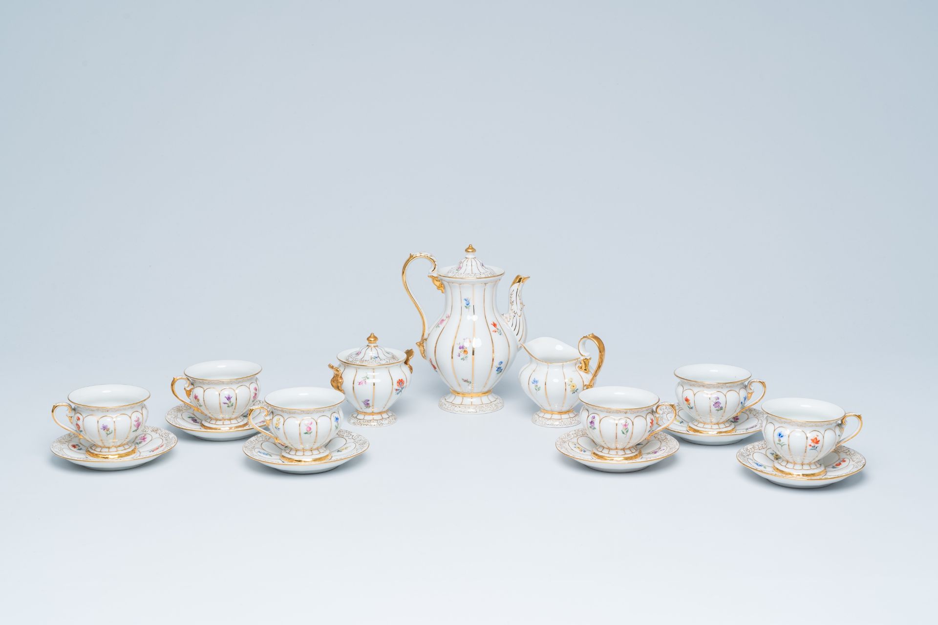 A German fifteen-piece polychrome and gilt Meissen mocha service with floral design, 20th C.