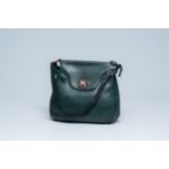 A Belgian green leather Delvaux shoulder bag with wood details, 20th C.