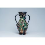 A large two-handled Flemish pottery Art Nouveau ewer with applied floral design, first half 20th C.