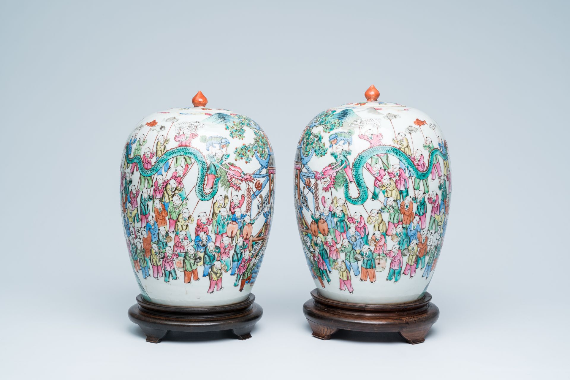 A pair of Chinese famille rose '100 boys' jars and covers, 19th C.