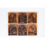 Six various carved wood reliefs depicting scenes from the life of a saint, Belgium, ca. 1900