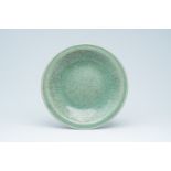 A large Chinese crackle-glazed celadon dish with underglaze floral design, 18th/19th C.