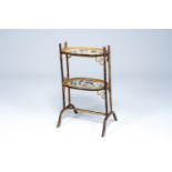 A Chinese etagere in partly black painted bamboo with two Canton famille rose celadon ground 'relaxi