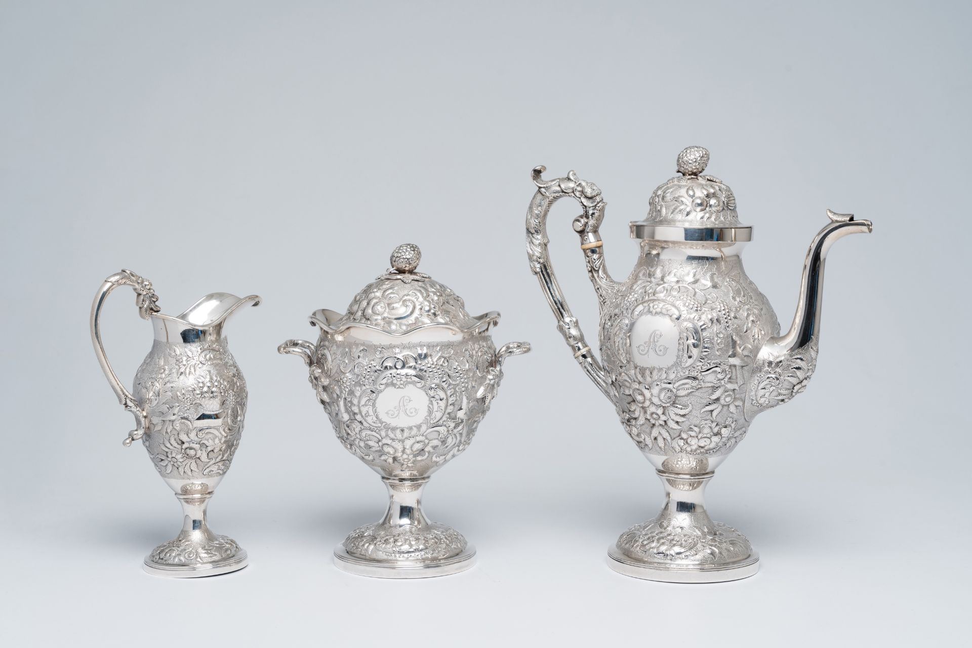 A three-piece American silver lush relief decorated coffee set, maker's mark Andrew Ellicott Warner,