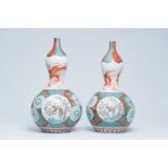 A pair of Japanese polychrome Arita double gourd vases with dragons and floral design, Meiji, 19th C