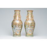 A pair of Chinese Canton famille rose gold ground vases with birds and butterflies among blossoming