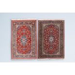 Two Persian Kashan rugs with floral design, wool on cotton, 20th C.