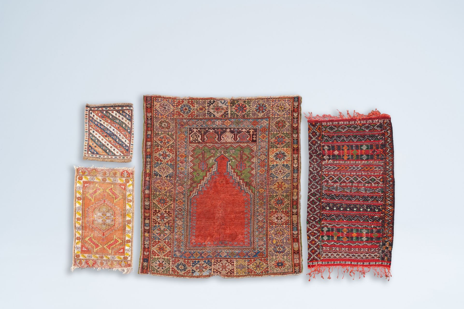 Four various Oriental rugs with geometric designs, wool on cotton, 20th C.