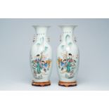 A pair of Chinese qianjiang cai vases with a lady, playing children and a cat in a garden, 19th/20th