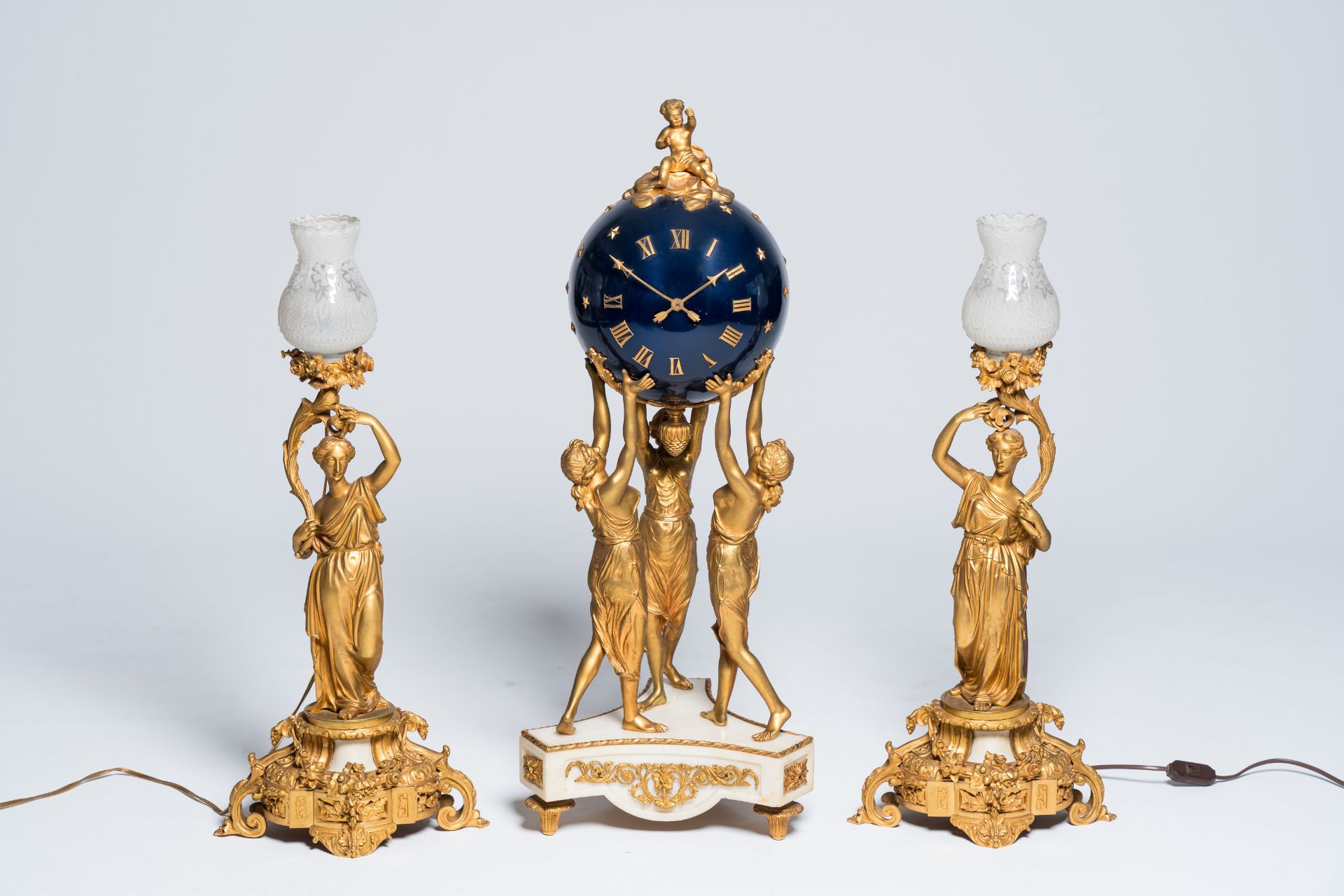 An imposing French three-piece gilt bronze and white marble 'Three Graces' clock garniture, 19th/20t