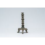 An Islamic bronze tripod candlestick with engraved design, SyriÃ«, 16th C. or earlier