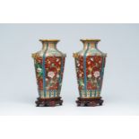 A pair of Chinese cloisonne vases with birds among blossoming branches on wood stands, Republic, 20t