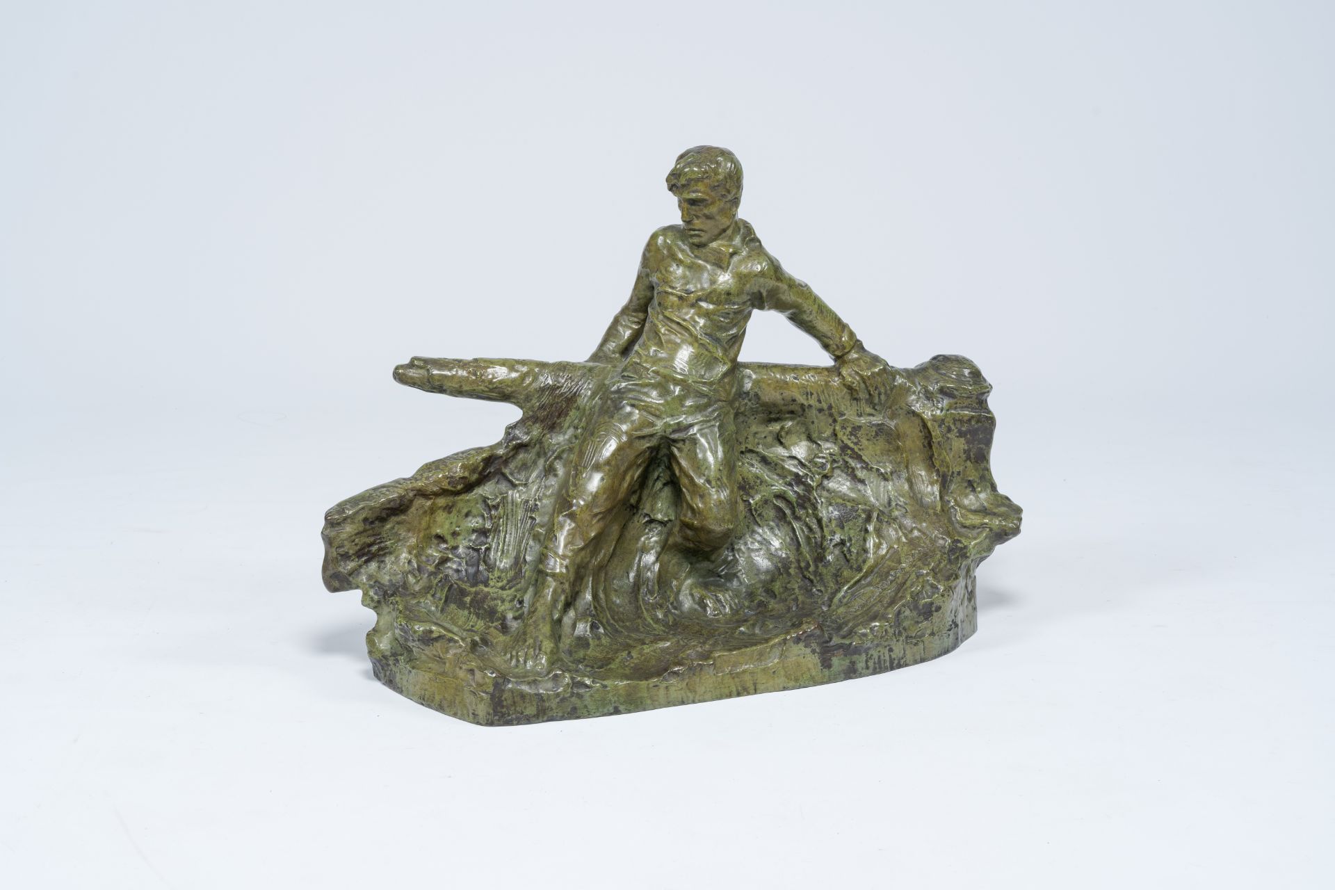 Victor Demanet (1895-1964): Man at the helm on a choppy sea, green patinated bronze