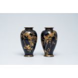 A pair of Japanese gold layered dark blue ground Satsuma vases with birds among blossoming branches,