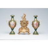 A French Louis XV style brass mantel clock and a pair of gold layered green ground Sevres style vase