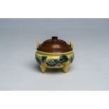 A Chinese verte biscuit yellow ground 'Buddhist lions' tripod censer, 19th C.