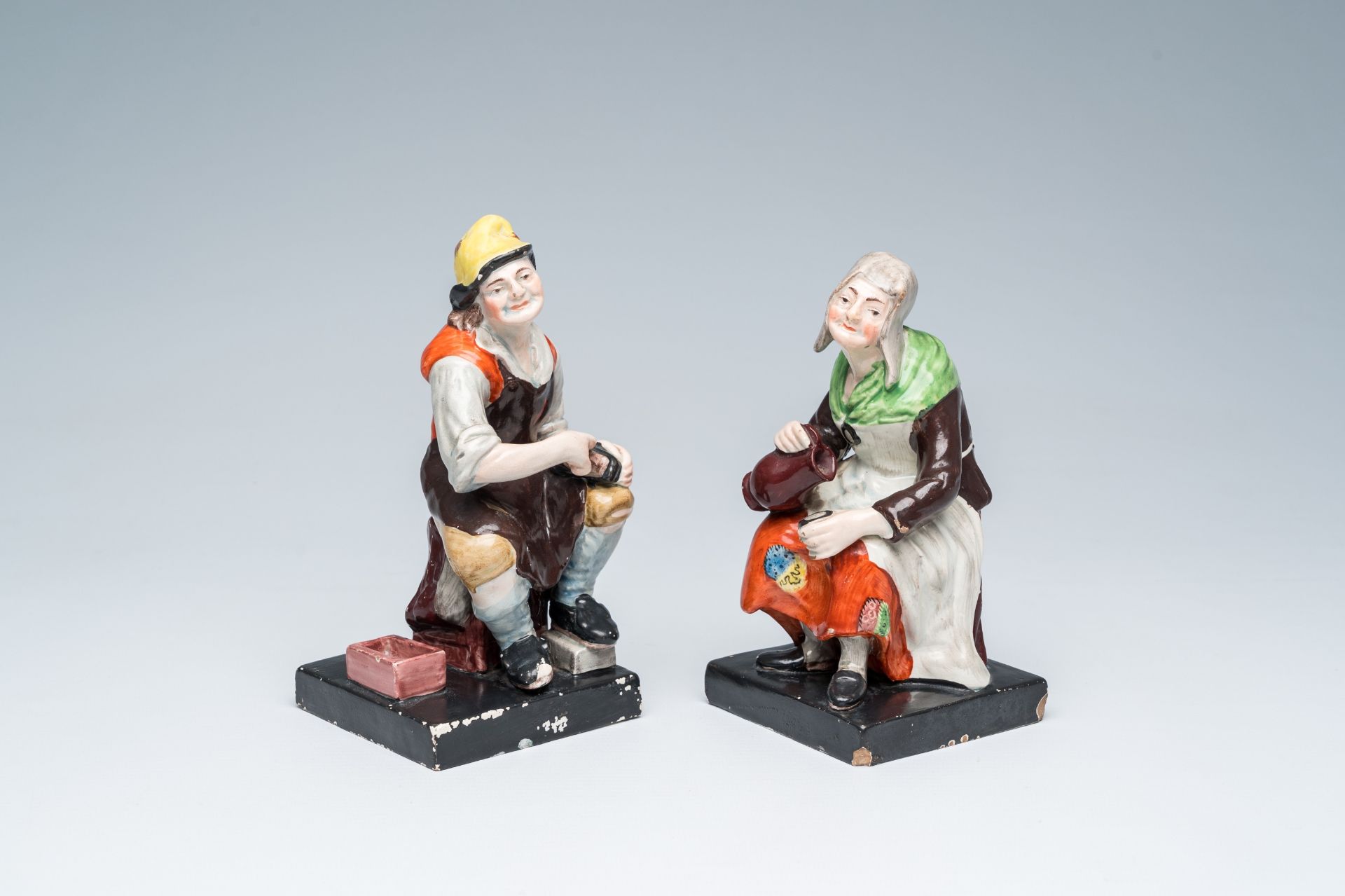 A pair of English Staffordshire 'Jobson and Nell' polychrome pottery figures, probably workshop Enoc