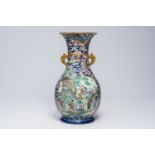 A large Chinese famille rose blue ground bottle vase with dragons, phoenixes and cartouches with ani