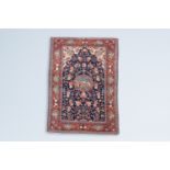 A Persian Kashan rug with floral design and cartouches with animals and landscapes, wool on cotton,