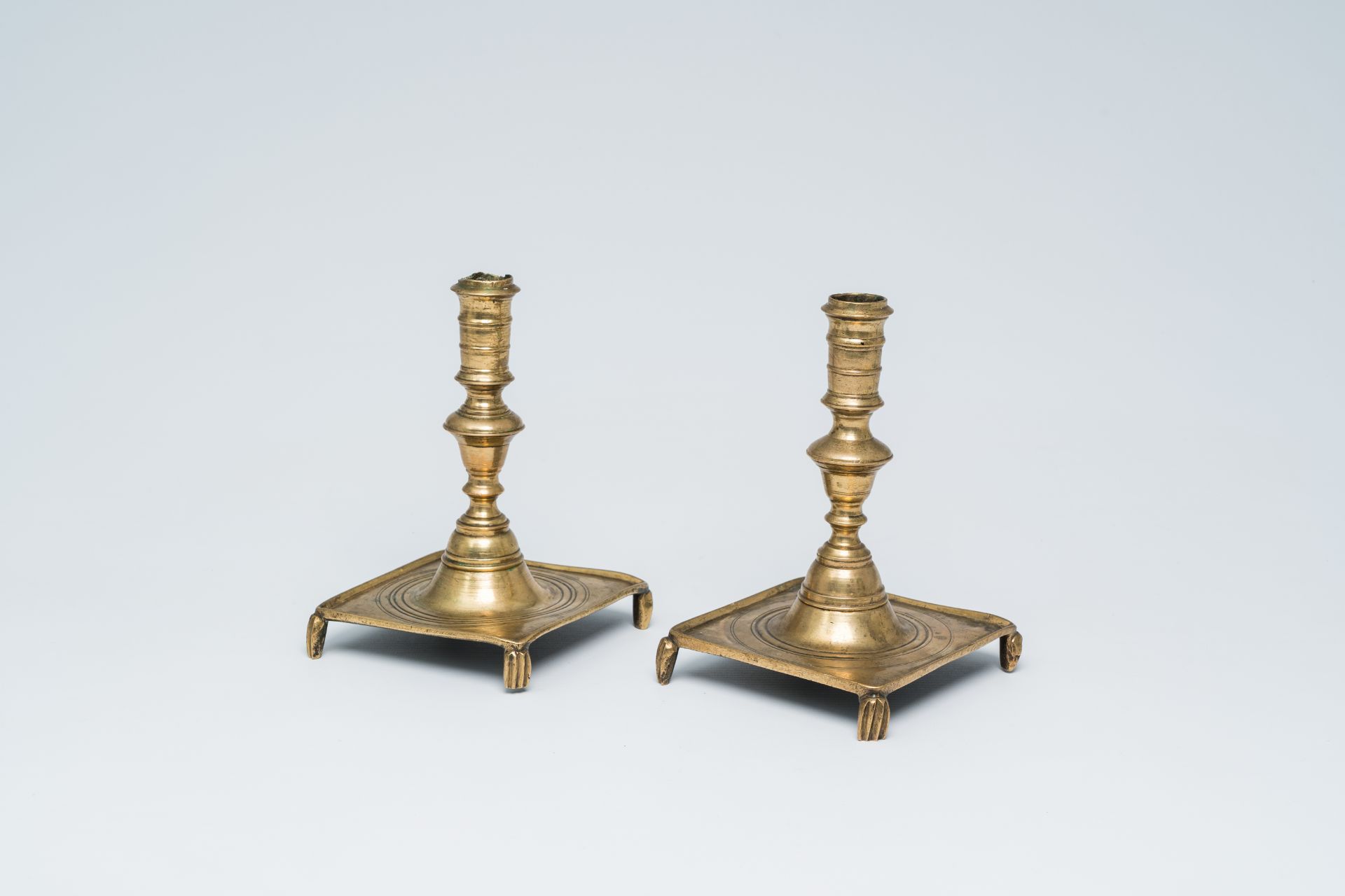 A pair of Spanish brass candlesticks, 17th/18th C.