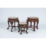 Three Chinese open worked carved wood stands with marble top, 20th C.