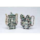 Two Chinese famille noire biscuit 'puzzle' teapots and covers with figures in a landscape and floral