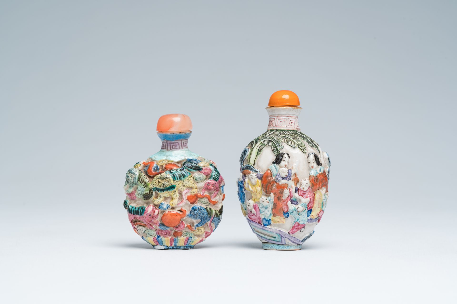 Two Chinese famille rose relief-molded snuff bottles, Qianlong mark, 19th C.
