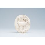 A German or Austrian basso relievo ivory plaque with a deer on a rock in a forest, late 19th C.