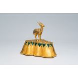 A gilt bronze sculpture of an antelope on a rock with inlay, Mouawad mark, Dubai, United Arab Emirat