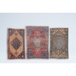 Three various Oriental and Caucasian rugs with geometric design and animals among blossoming branche