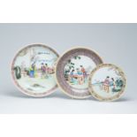 A Chinese famille rose plate and two chargers with figures in a garden, Qianlong marks, 20th C.
