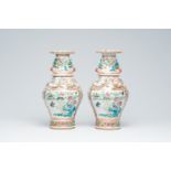 A pair of Chinese Canton famille rose vases with birds and butterflies among blossoming branches and