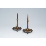 A pair of Flemish or Dutch Gothic Revival bronze tripod candlesticks, 19th C.