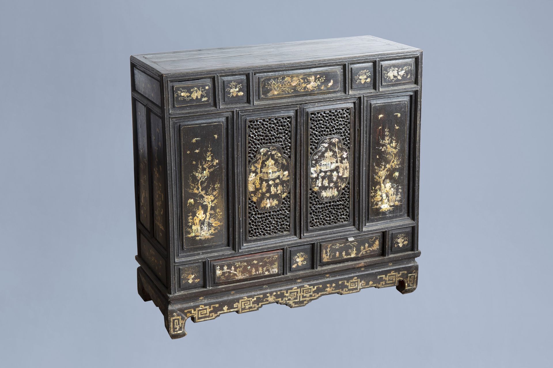 A Vietnamese mother-of-pearl inlaid wood two-door cabinet with figures in a palace garden and floral